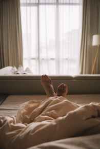 feet of a person in bed