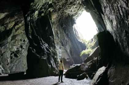 person standing inside cave